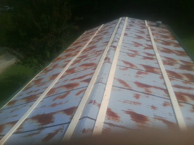 Rusted metal roof panels with new wood purlins before replacement — Storm Damage Roof Repair in Limekiln by Roofing Brothers