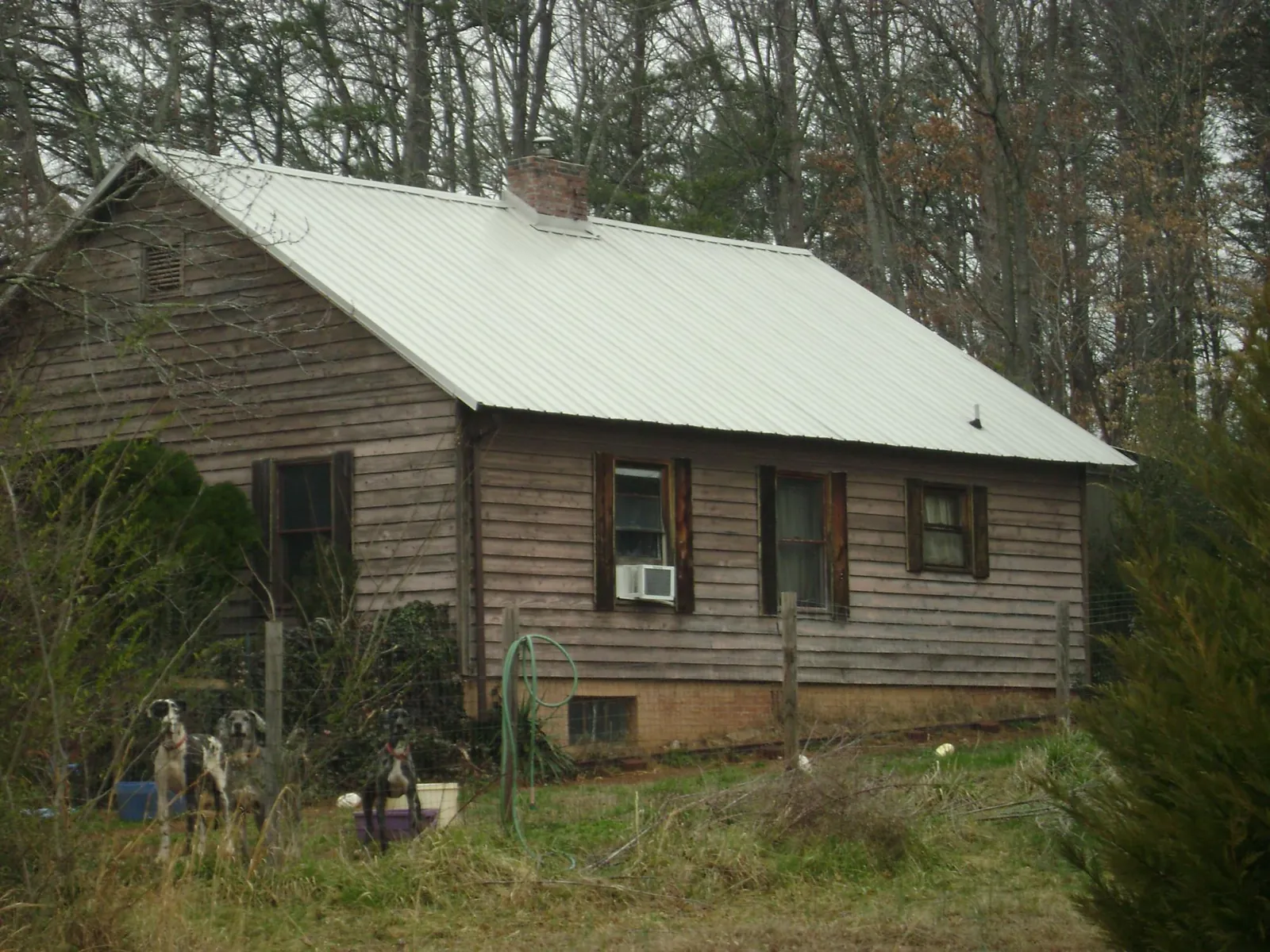 White metal roof on an old wood sided farmhouse, from a Metal Roof Installation job in Limekiln